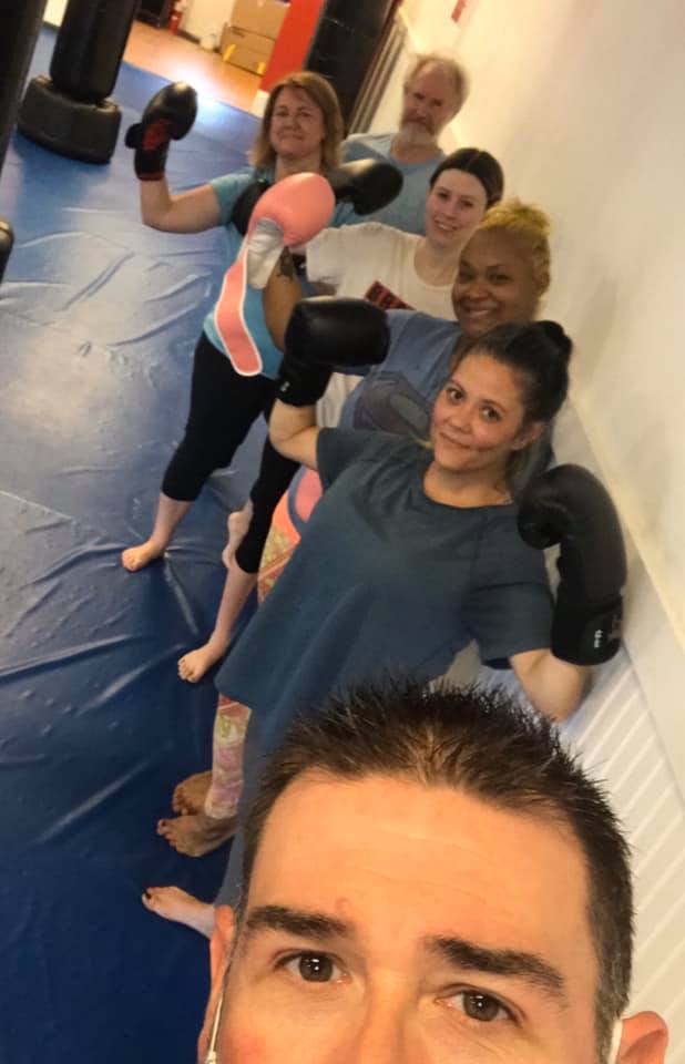 Woman stretching before cardio kickboxing workout in Grayson GA studio