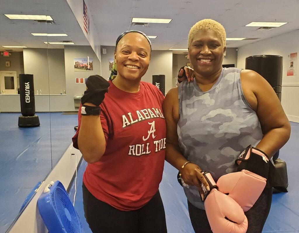 “Fit woman kickboxing in studio with toned arms”