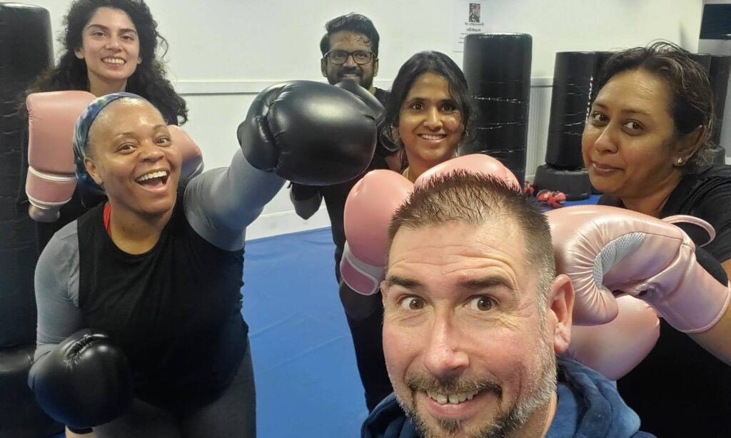 Group fitness kickboxing class with high energy