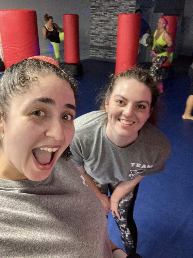 “Woman kicking heavy bag at Braselton GA fitness kickboxing studio”