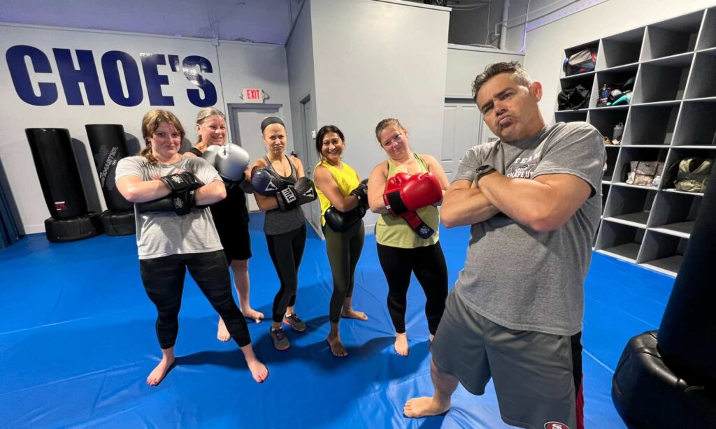 Modern fitness kickboxing class with instructor