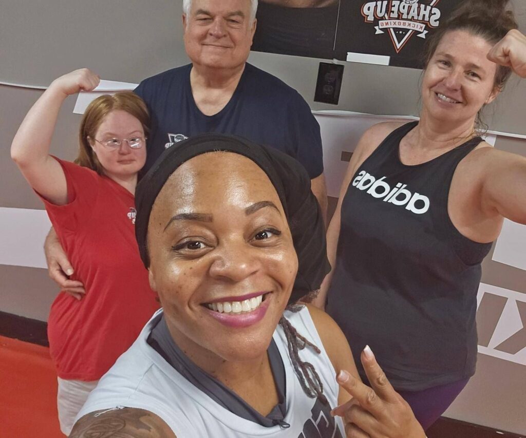 Kickboxing class participants celebrating fitness goals