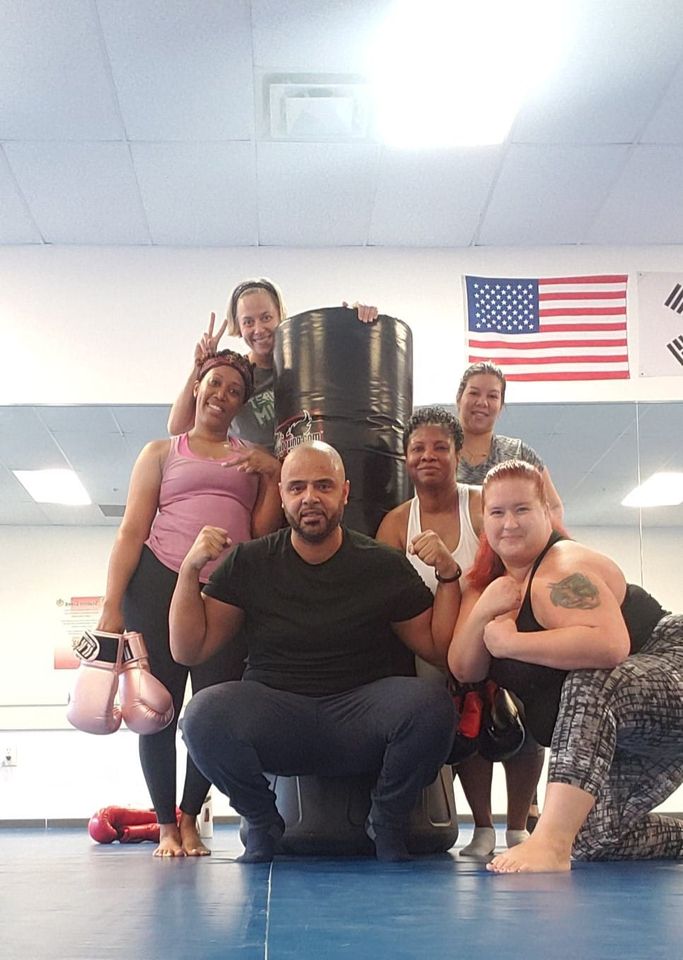 Member choosing happy during a kickboxing class at Shape Up Kickboxing Grayson GA