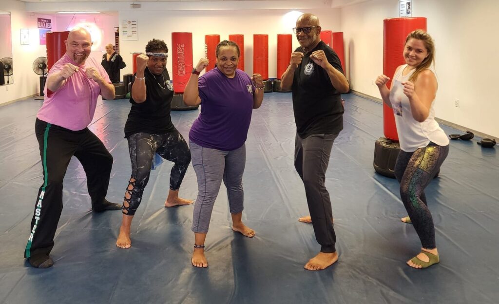 Group kickboxing workout with punching bags