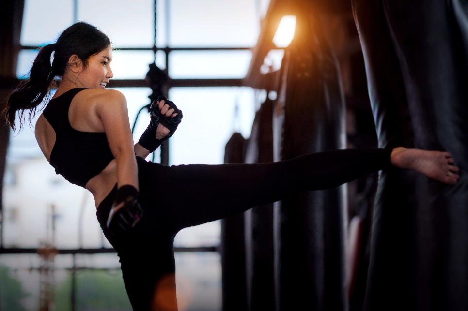 “Kickboxing class doing high knees during HIIT warm-up”
