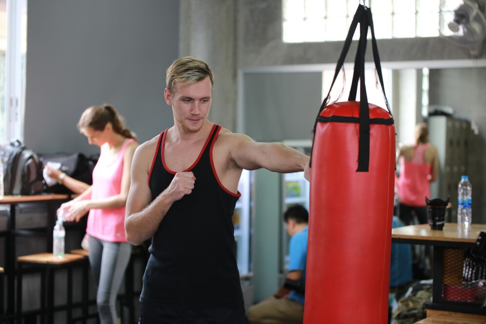 Man boxing with a heavy punching bag